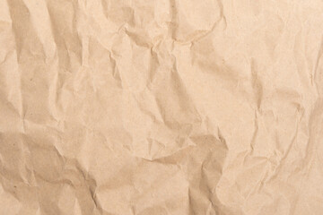 Crumpled brown paper texture perfect for background structure. Packaging material with rough wrinkles. The grunge textured surface is a vintage backdrop.