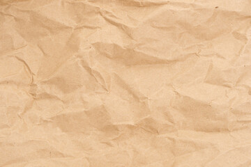 Crumpled brown paper texture perfect for background structure. Packaging material with rough wrinkles. The grunge textured surface is a vintage backdrop.