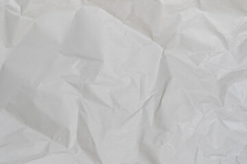 Crumpled white paper texture perfect for background structure. Packaging material with rough wrinkles. The grunge textured surface is a vintage backdrop.