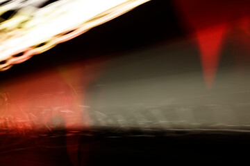 Abstract background with black space created in camera with lines of red and white spectrums of light. Stock Photo.