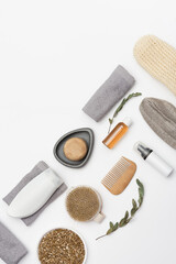 Naklejka premium Flat lay composition with bath accessories with bottles with gel or shampoo, soap, sea salt, washcloth, wooden comb