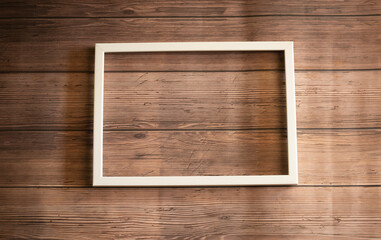 White photo frame on wooden background