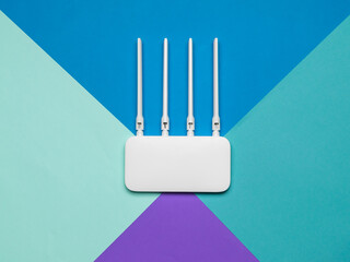 Wi-Fi router with four antennas on a four-color background.