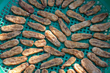 Sun-dried banana in a plastic basket is food preservation.