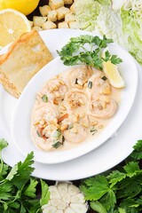 Tender shrimps in a sauce with pine nuts. Restaurant serving concept. Close-up.