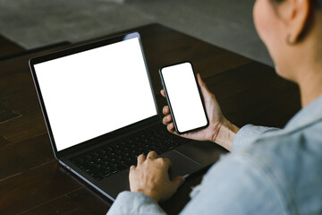 computer screen,cell phone blank mockup.hand woman work using laptop texting mobile.with white background for advertising,contact business search information on desk in cafe.marketing,design