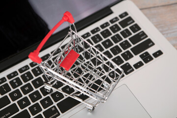 Shopping cart model on laptop keyboard