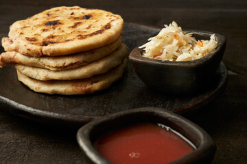 Traditional salvadoran breakfast and dinner, corn tortillas filled with pork, cheese and beans, pupusas