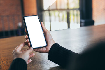 cell phone blank white screen mockup.woman hand holding texting using mobile on desk at office.background empty space for advertise.work people contact marketing business,technology