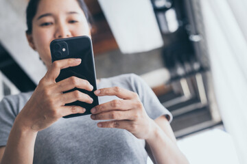 using cell phone hand holding mobile texting message contact us.chatting,search internet information in office.technology device communication connecting