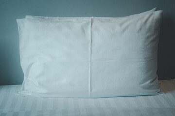 White pillows on bed close up
