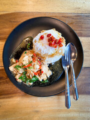 Rice topped with stir-fried chicken and basil with fried egg