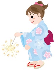 線香花火をする浴衣姿の女の子