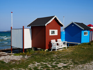 Fototapeta na wymiar Beautiful cute little wooden beach huts summer houses, painted in lively colors, Aero Island, South Funen, Denmark
