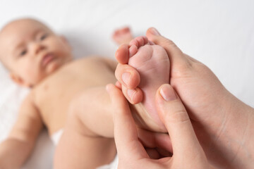 Obraz na płótnie Canvas Masseur giving foot massage to baby. Selective focus