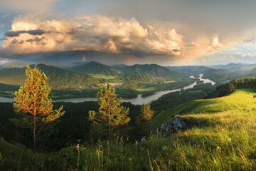 Naklejka premium Thundercloud over the valley. The Katun River, Altai. Sunset light.
