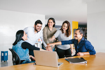 Group of latin business people working together as a teamwork while sitting at the office desk in a creative office in Mexico city
