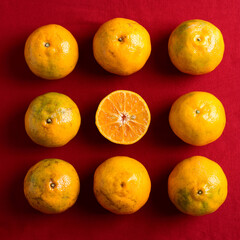 Tangerine orange fruit on red background, Chinese New Year concept