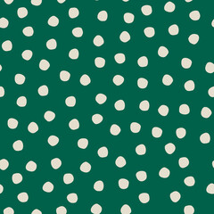 Seamless hand drawn rustic polka-dot pattern on green background for surface design and other design projects