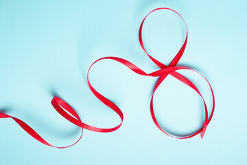 Red gift celebration ribbon in 8 digit shape. Happy woman's day
