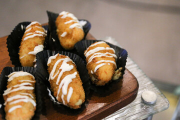 Potato croquettes with mayonnaise on the wooden board