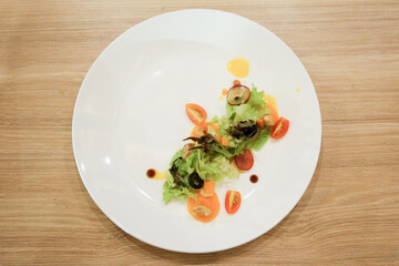 Fresh healthy salad and vegetable on a white plate.