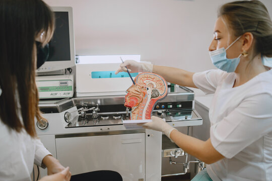 Woman patient in the medical office. Doctor in medical mask.