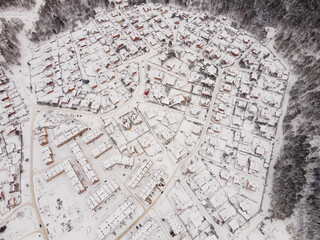 Many snow-covered buildings taken from the air. Village in the snow