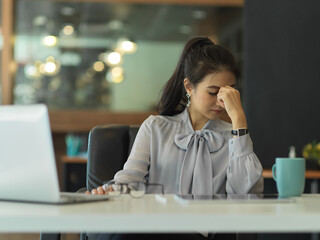 Businesswoman felling upset while working in her office room