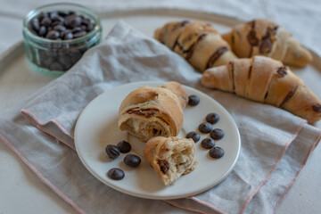 home made croissant filled with chocolate on a plate