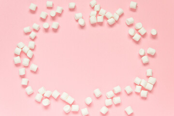 Marshmallow frame on a pink background. Concept of love, happy valentine's day, women's day and birthday celebration. Flatly, copy space, mock up, banner.