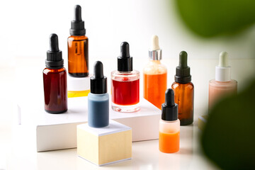 Bio serum, natural oil and cream on the podium at white background with plant leaf. Natural cosmetic for perfect skin care concept.