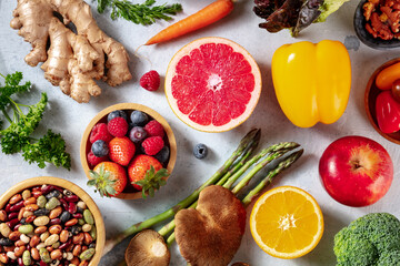 Vegan food, overhead flat lay shot. Grapefruit, asparagus, and other superfoods, healthy organic ingredients
