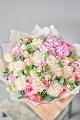 Beautiful bouquet of mixed flowers on wooden table. the work of the florist at a flower shop. Delivery fresh cut flower. European floral shop.