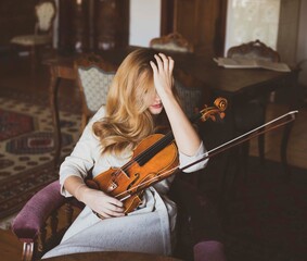 Young woman with a violin at home  © rubchikova