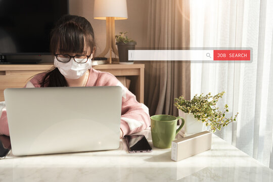 A young asian woman wearing medial face mask using computer laptop to search for a new job as COVID-19 crisis is profoundly affected employment. Search tools, Unemployment, Hope, Financial crisis