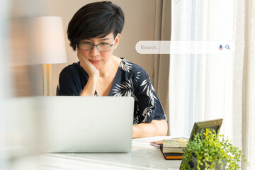 Search Engine Optimization - SEO concept. Portrait of a beautiful middle-aged asian woman using...