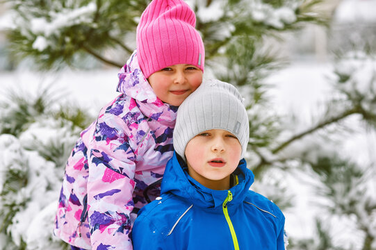 Portrait of children on a winter walk . Children enjoy the first snow