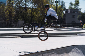 young latin man doing tricks on a bicycle. BMX concept
