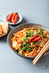 Asian food, wok noodle and vegetables in ceramic bowl, selective focus