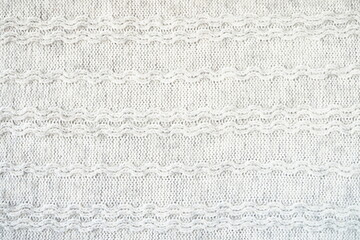 The texture of the woollen product. Grey background. High quality