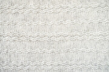 The texture of the woollen product. Grey background. High quality