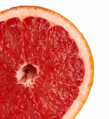 red grapefruit lies on a red background