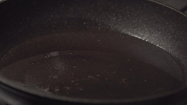 Dranki, potato pancakes are put in a frying pan. Russian traditional food