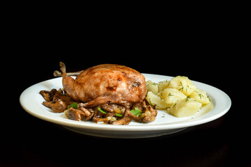 Baked mushrooms stuffed quail with fried chanterelles.