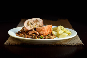 Baked mushrooms stuffed quail with fried chanterelles.