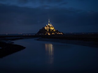 Panorama landscape night view of Mont Saint Michel famous remote isolated island rock castle town...