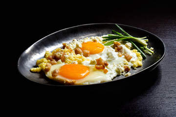Fried eggs with polenta, green onions, cheese and cracklings.