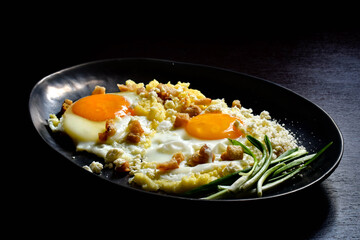 Fried eggs with polenta, green onions, cheese and cracklings.