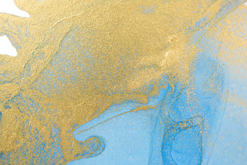 Blue and gold ink drops mixed with gold powder.